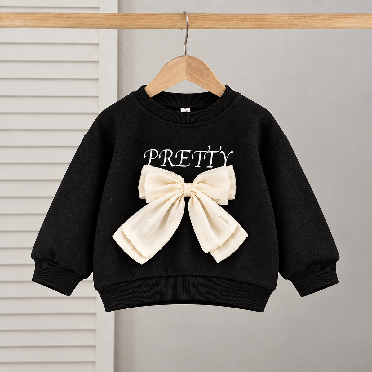 Tenue élégante pour fille avec une touche moderne - haut noir avec nœud papillon élégant et jean plissé attrayant