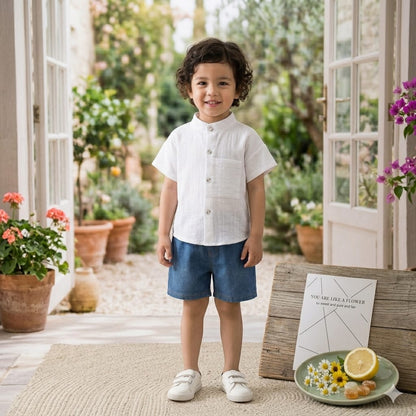 Stylish kids' outfit with a modern design, featuring a button-up shirt and denim shorts – perfect for a comfortable and coordinated look on sunny days!