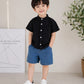 Stylish kids' outfit with a modern design, featuring a button-up shirt and denim shorts – perfect for a comfortable and coordinated look on sunny days!